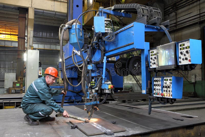 Automated submerged arc welding process. St. Petersburg, Russia - October 10, 2014: Industrial processing metal, automated submerged arc welding process. Work royalty free stock photos