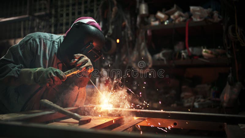 Gas welding with workpiece steel.working person in factory industry. Working person About welder steel Using gas welding machine There are lines of light coming stock images