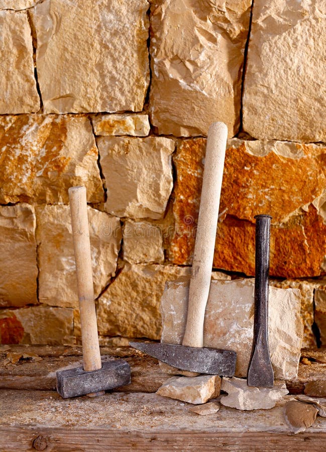 Hammer tools of stonecutter masonry work. Hammer mason tools of stonecutter masonry work in a contruction stone wall royalty free stock images