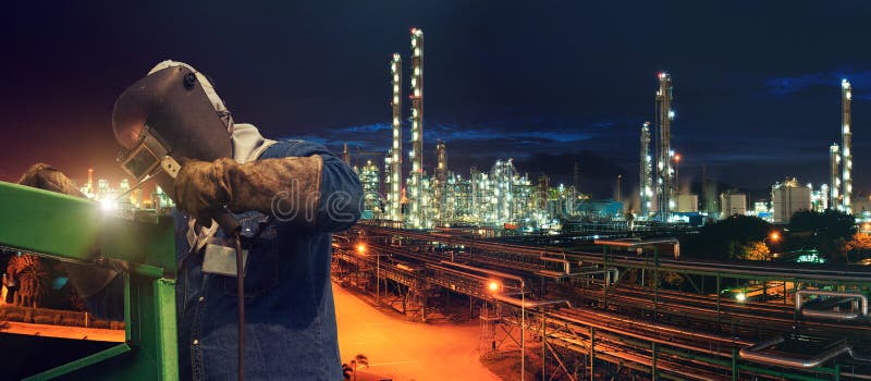 Industrial welding worker at the petrochemical plant. Industrial welding worker at the petrochemical oil and gas plant royalty free stock photography