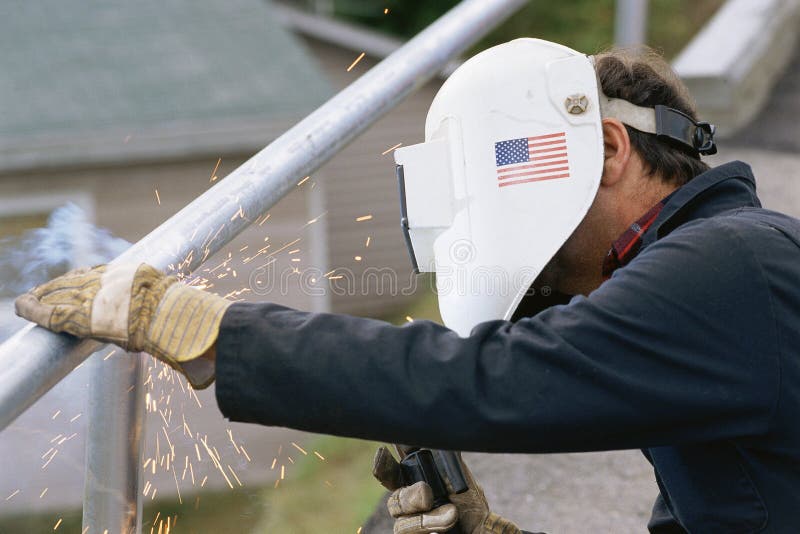 Man welding. A steel railing royalty free stock photos
