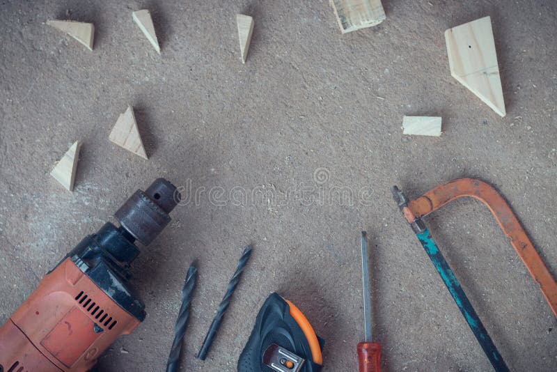 Top view, Carpenter work area with many tools and scantling on Dusty concrete floor, Craftsman tools set. Space for text royalty free stock photos