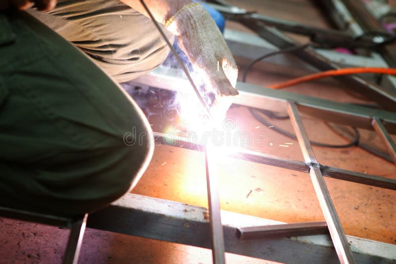 Welding. Worker welding on a structure stock photo