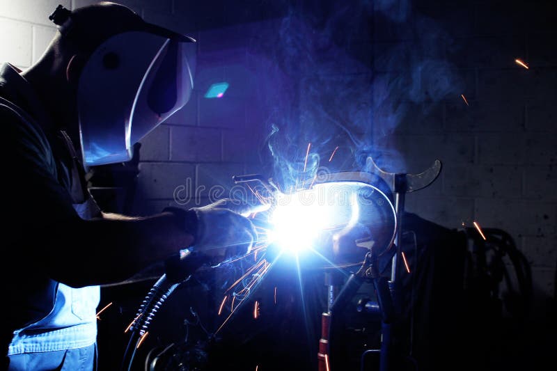 Welding steel and sparks. A metalworker welding a metal construction stock photo