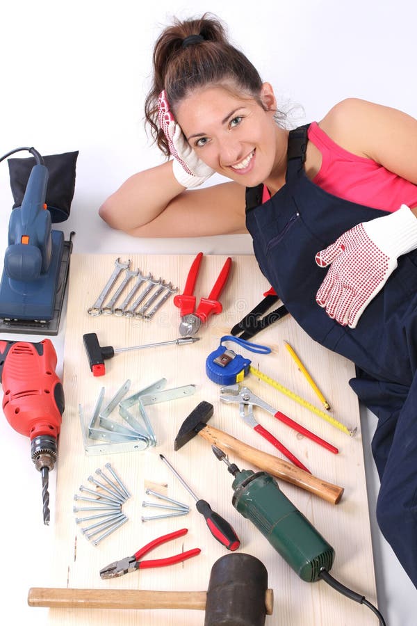 Woman carpenter with work tools. On wooden plank stock photo