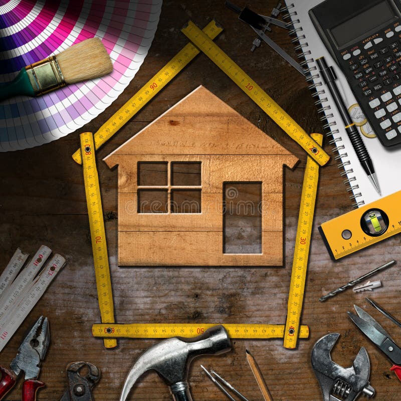 Work Tools and Model House - Home Improvement. Home improvement concept - Wooden model house with work tools and a calculator on a wooden desk stock photography